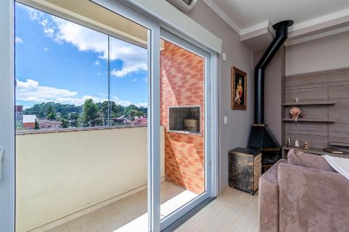 a room with a large window with a view at Apartamento Pedras Altas in Canela