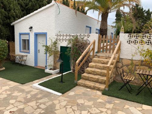 a white building with a staircase next to a house at Centauro in Albir