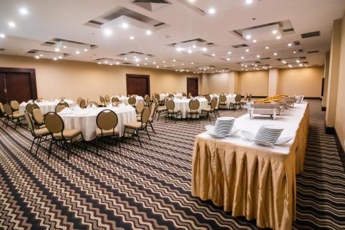a banquet hall with white tables and chairs at Eurobuilding Hotel & Suites Guayana in Puerto Ordaz
