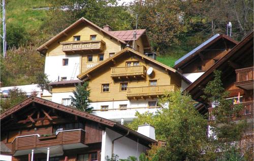 a large wooden building with balconies on a mountain at Ferienwohnung In Tiroler Stil in Kappl