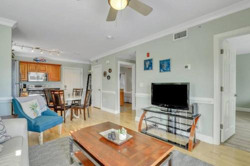 a living room with a flat screen tv and a table at 2 Bed Condo Walk to the Beach in Tybee Island