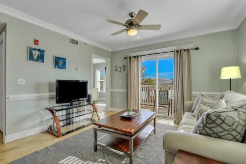 a living room with a couch and a tv at 2 Bed Condo Walk to the Beach in Tybee Island