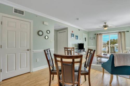 a dining room and living room with a table and chairs at 2 Bed Condo Walk to the Beach in Tybee Island