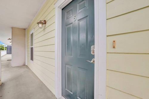 a blue door on the side of a house at 2 Bed Condo Walk to the Beach in Tybee Island