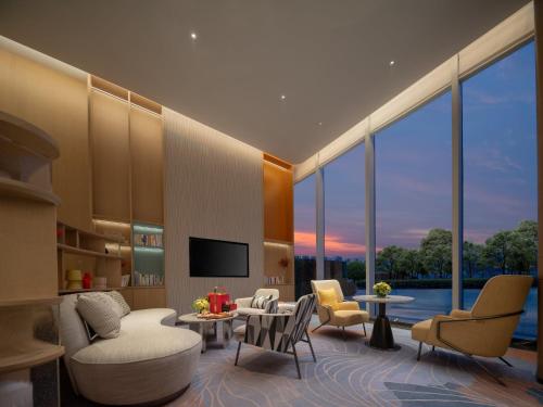 a living room with a lot of windows at Holiday Inn Chengdu East, an IHG Hotel in Chengdu