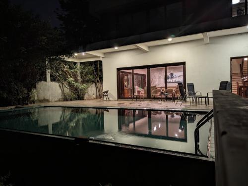 a house with a swimming pool at night at Thalangama Lakeview Lodge in Battaramulla