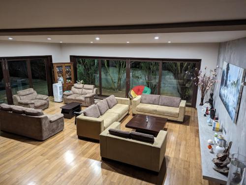 a large living room with couches and a table at Thalangama Lakeview Lodge in Battaramulla