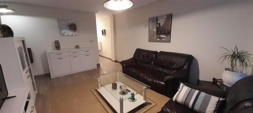a living room with a couch and a coffee table at Apartamentos Maliayo Villaviciosa in Villaviciosa