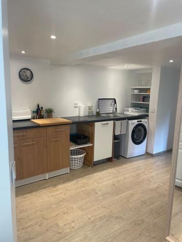 une cuisine avec un comptoir et un lave-linge/sèche-linge dans l'établissement Maison de village au pied du Luberon., à Peypin-dʼAigues