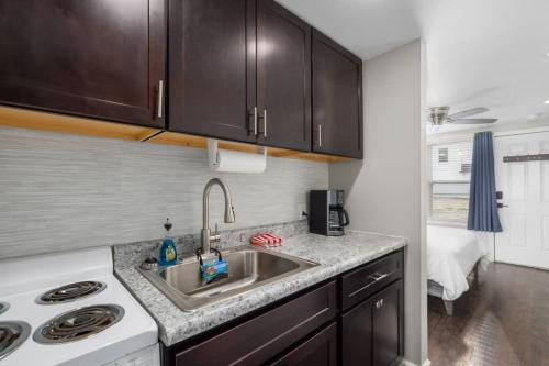 a kitchen with a sink and a stove at Downtown Kimmswick Room~Renovated~Prime Location in Imperial