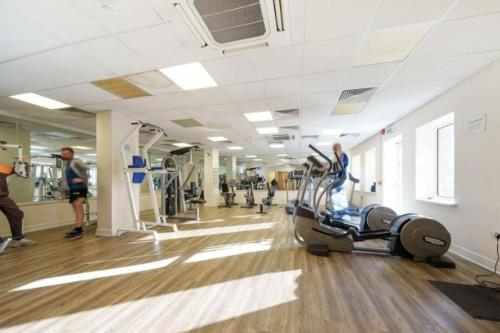 a gym with a person on a exercise bike at Stratford Apartment - walk to ABBA Voyage in London