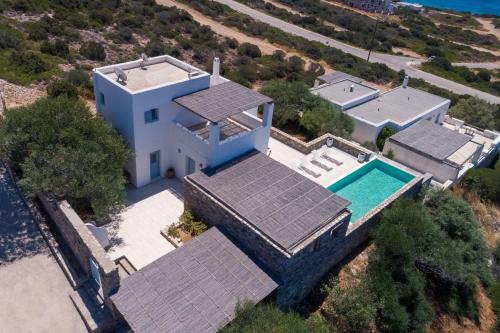an aerial view of a house with a swimming pool at VILLA ERIS in Agios Georgios