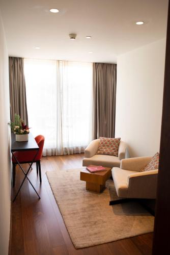 a living room with two couches and a table at Hotel Carris Porto Ribeira in Porto