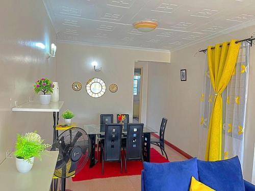 a dining room with a table and chairs at Homely apt 3 (three) in Kisumu