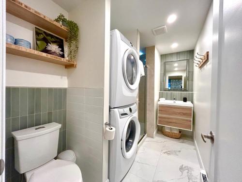 a bathroom with a washing machine and a toilet at MTLVacationRentals - The City Chalet in Montréal