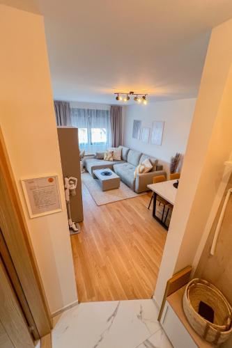 a living room with a couch and a table at Apartment Forma in Zlatibor