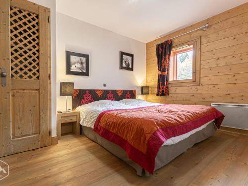 a bedroom with a bed and a window at Appartement Lanslebourg-Mont-Cenis, 3 pièces, 6 personnes - FR-1-508-300 in Lanslebourg-Mont-Cenis