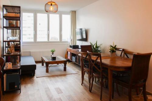 un salon avec une table et une salle à manger dans l'établissement Bright nest - view on the top of the Eiffel Tower, à Paris