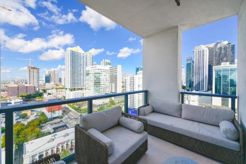 a balcony with two couches and a view of a city at Prime location: Luxury Condo at brickell in Miami