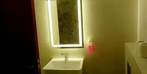 a bathroom with a white sink and a window at P.A.S.H.A BOUTIQUE HOTEL in Amman