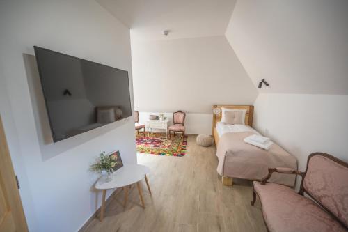 a living room with a bed and a flat screen tv at Konak Lecic in TrÅ¡iÄ‡