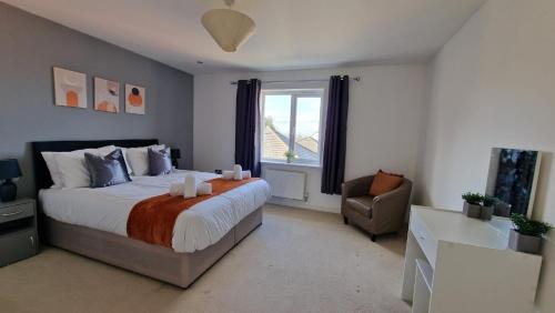 a bedroom with a bed and a chair and a window at Margam's Alvington House for Business Travellers, Relocator or Families with FREE Parking, High Speed Internet and fully equipped kitchen 