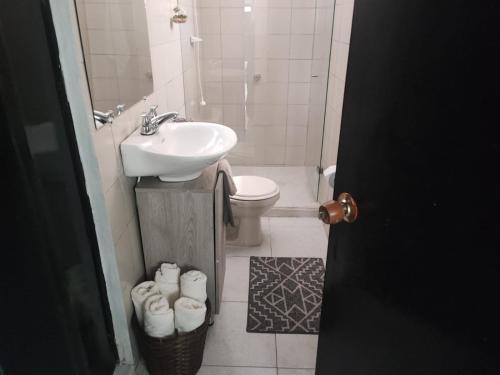 a bathroom with a sink and a toilet and a sink at Habitación en encantadora casa en Itagui in Itagüí