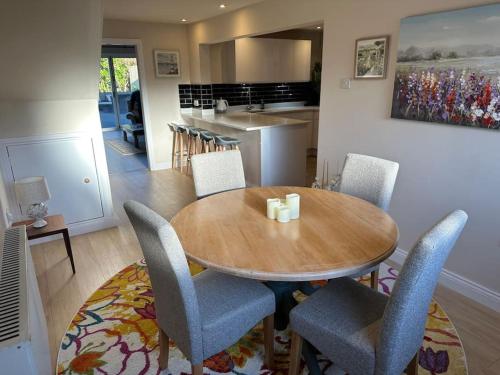 a dining room with a wooden table and chairs at Lovely country cottage in Dalton / Parbold in Wigan