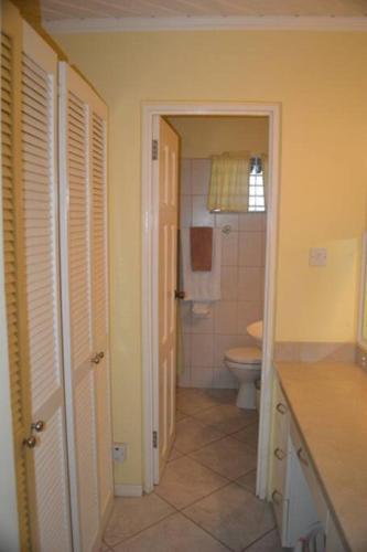 a bathroom with a toilet and a sink at Studio apartment in heart of south coast Barbados in Bridgetown