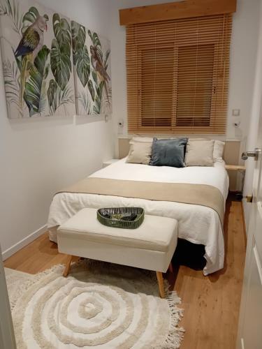 a bedroom with two beds and a table and a window at Bonavista Montgat in Montgat