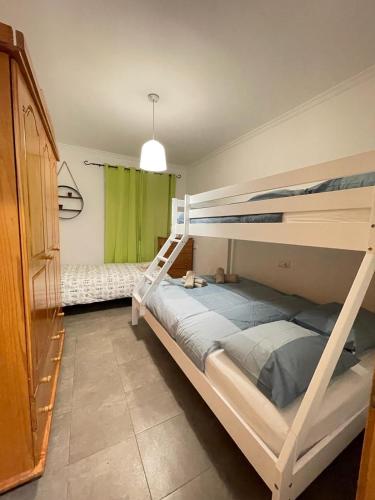 a bedroom with two bunk beds and a green window at UIM Mediterraneo PB Miguel Hernandez Wifi in Puerto de Sagunto