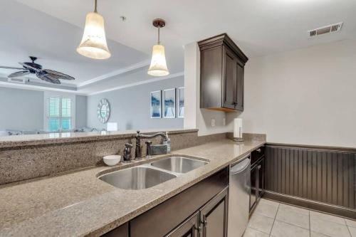 a kitchen with a sink and a counter top at Atlantic Ave: 3 Bed 2 Bath Condo Walk to Beach in Tybee Island