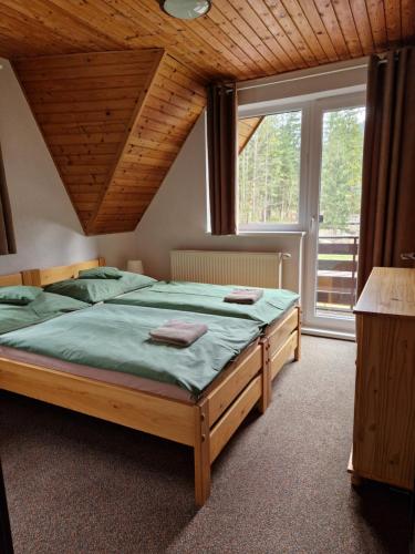 Postel nebo postele na pokoji v ubytování Chata Adam