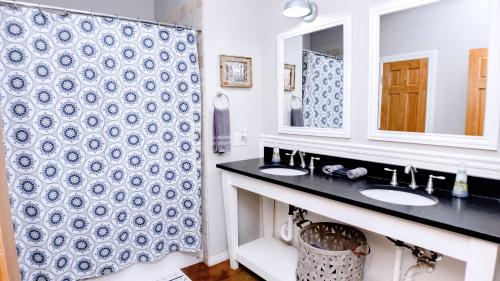 a bathroom with two sinks and a shower at Gray House in Hulbert