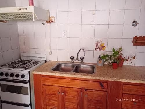 a kitchen with a sink and a stove at Departamento"la casa de catita "la pampa general pico in General Pico