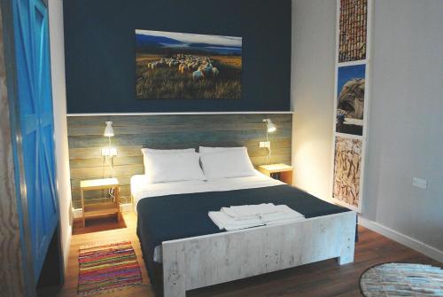 una camera da letto con un letto e un dipinto di un gregge di pecore di Maramare Pinus a Stara Baška