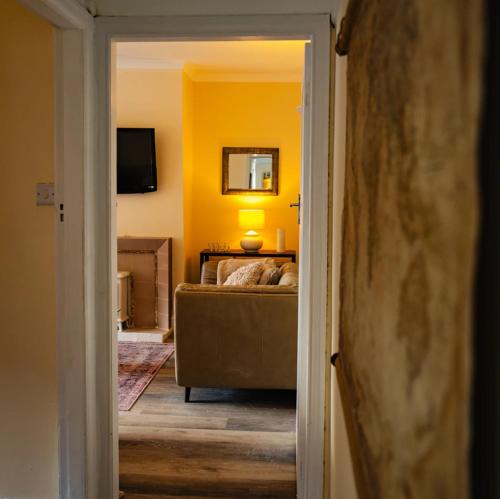 a bedroom with a bed and a couch in a room at Beach House in Whitley Bay