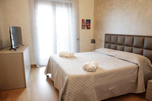 a bedroom with a bed with two towels on it at unica affittacamere in Rome
