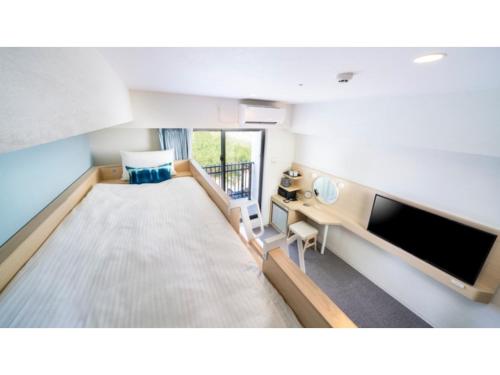 a hospital room with a bed and a tv at Hotel Torifito Miyakojima Resort - Vacation STAY 79480v in Miyako Island