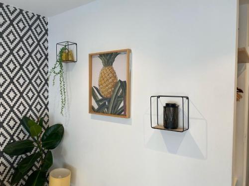 a picture of a pineapple hanging on a wall at Madeira Guest House in Brighton & Hove