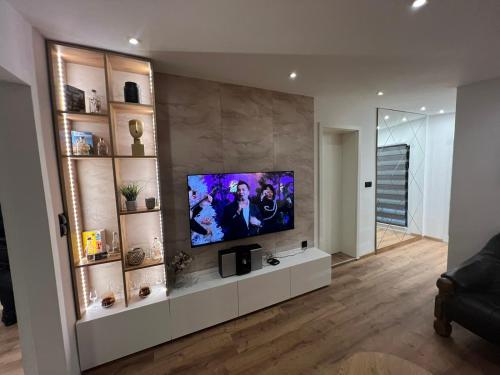 a living room with a flat screen tv on a wall at Ferienwohnung E in Soltau