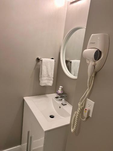 a bathroom with a white sink and a mirror at Niagara Getaway across Fallsview in Niagara Falls