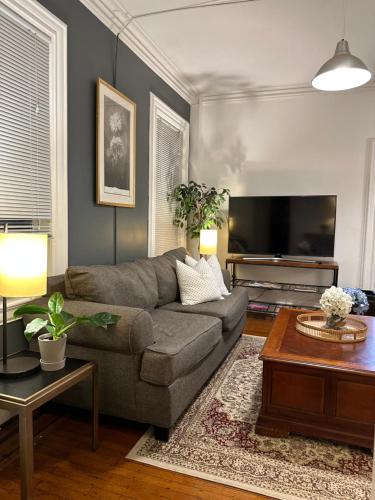 a living room with a couch and a tv at Cozy 2B1B Home ｜Walk to BROWN｜RISD｜Pet friendly in Providence
