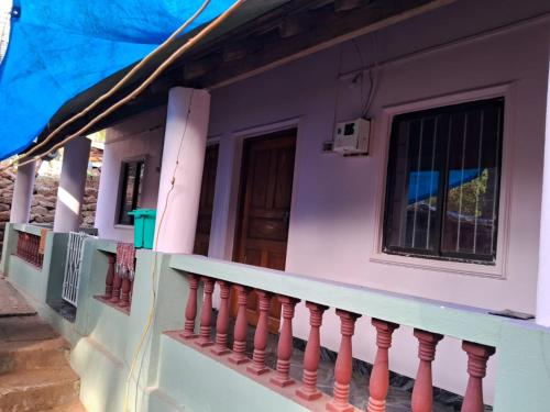 a facade of a house with a balcony at Dias guest house in Canacona