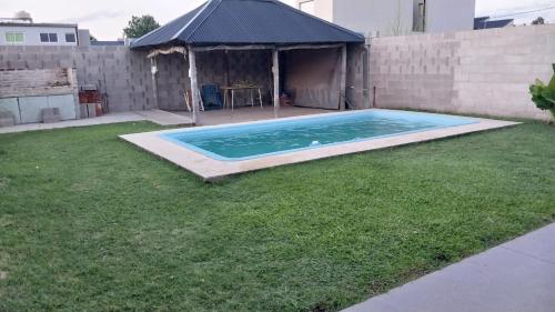 um quintal com uma piscina na relva em Casa con pileta Matheu em Junín