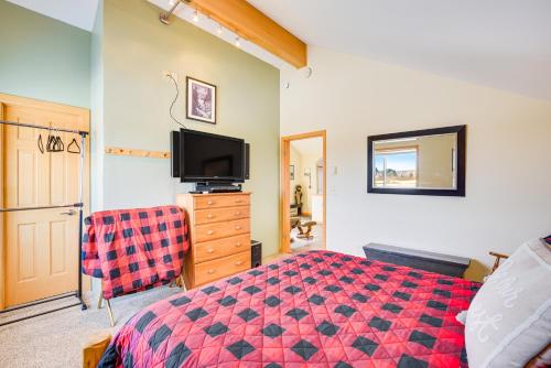 a bedroom with a bed and a flat screen tv at Duluth Studio with Sauna on Working Horse Farm! in Duluth