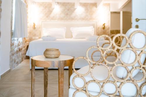 a bedroom with a bed and a table and chairs at PARGA Villas Collection in Parga