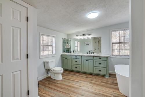 a bathroom with a toilet and a sink and a tub at Waterfront Louisiana Home with Private Boat Launch! in Alliance