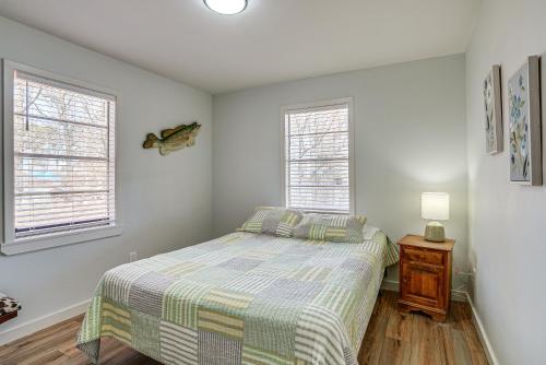 a bedroom with a bed and two windows at Waterfront Louisiana Home with Private Boat Launch! in Alliance