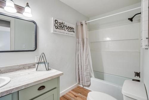 a bathroom with a sink and a toilet and a tub at Waterfront Louisiana Home with Private Boat Launch! in Alliance